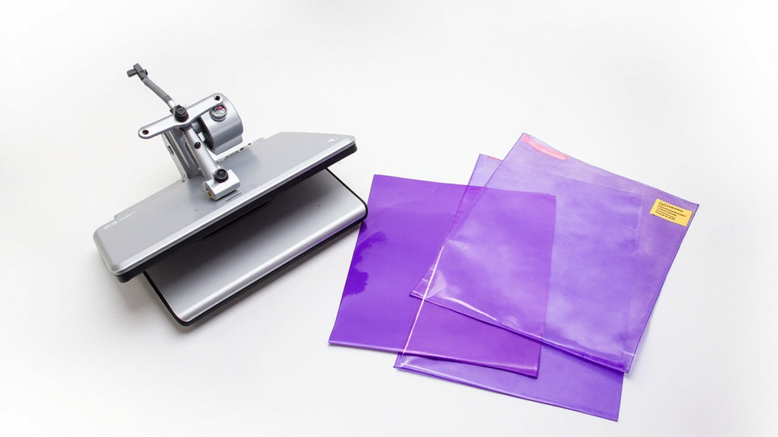 vibrant dtf transfer sheets beside heat press in bright clean studio